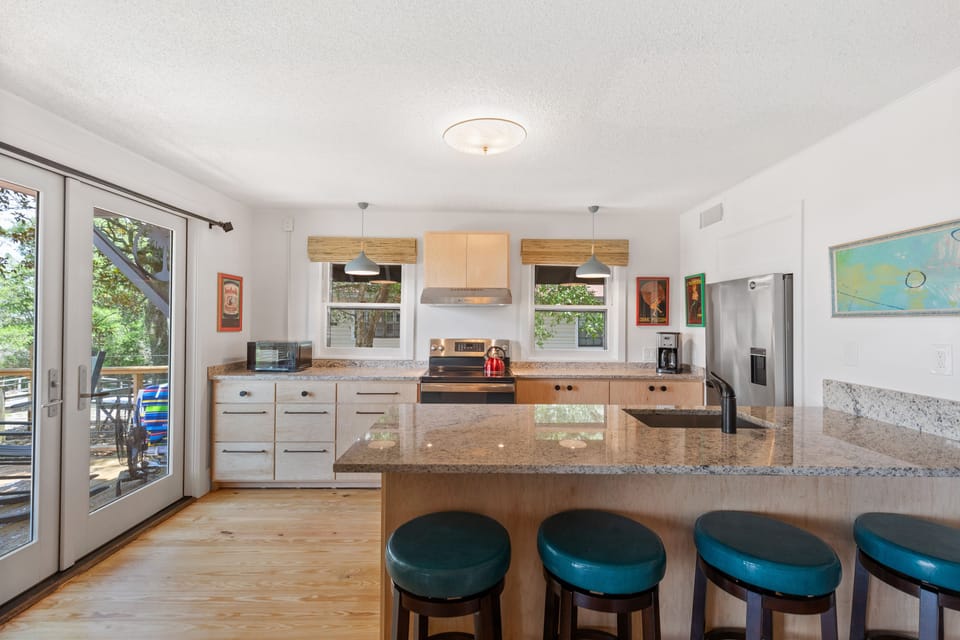 The kitchen in the home boasts a four person breakfast bar, updated appliances, and french doors leading to the spacious deck.