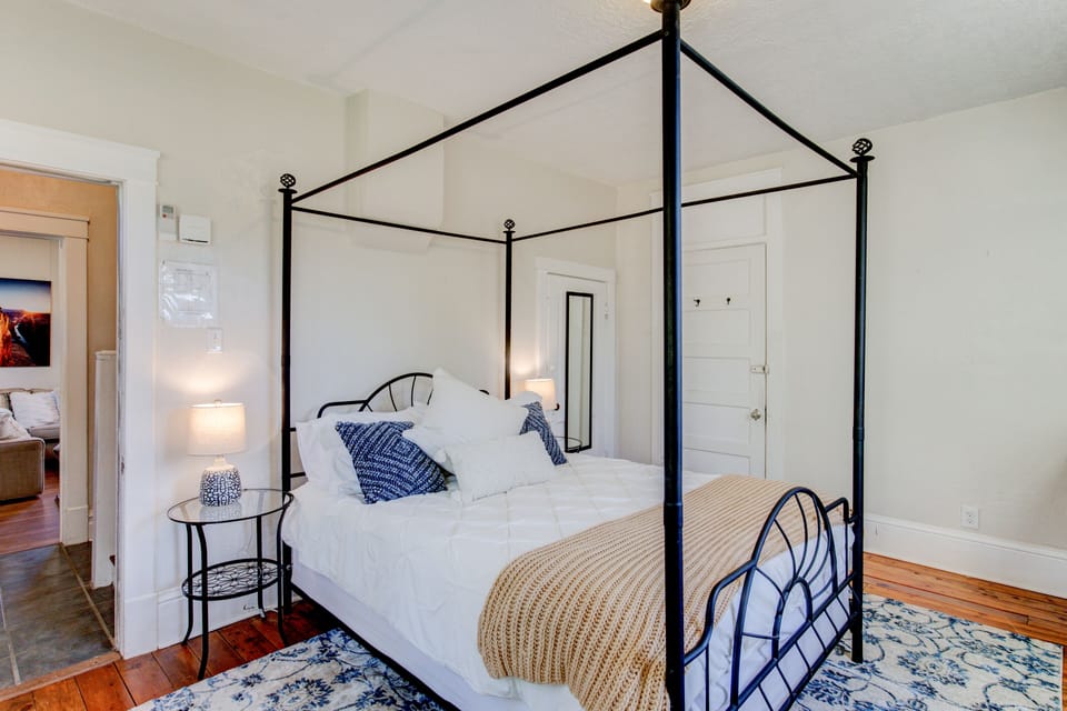 Master bedroom with a queen canopy bed