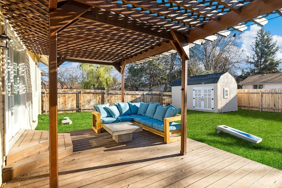 Large back patio with seating and yard games.