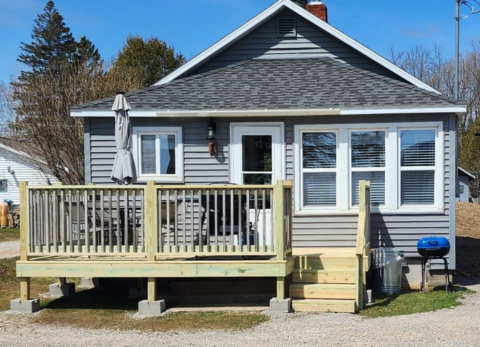Table,chairs, umbrella, gas grill. Charcoal grill & picnic table below deck