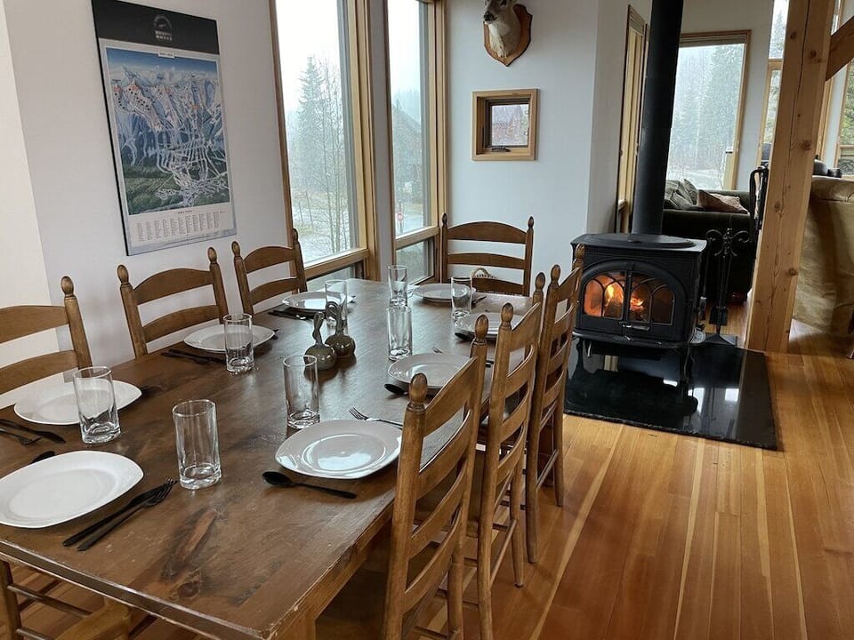 Lots of space around the table to gather for meals and warm up by the wood stove