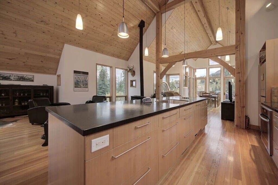 Six stools at the island to enjoy the beautiful architecture and sweeping post and beam ceilings