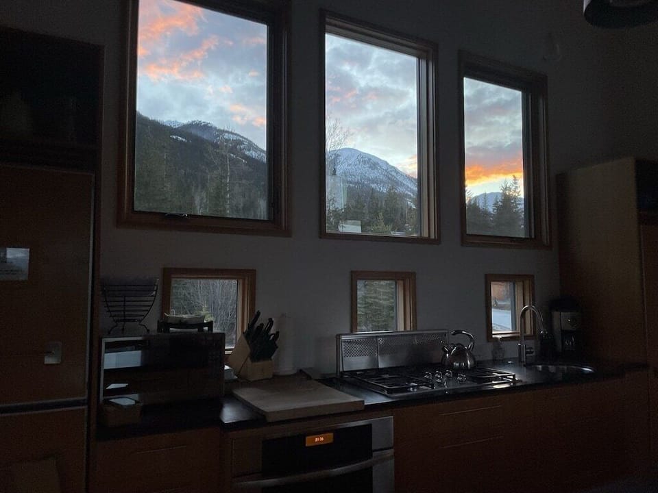 Views of the sun setting behind the mountain from the Kitchen