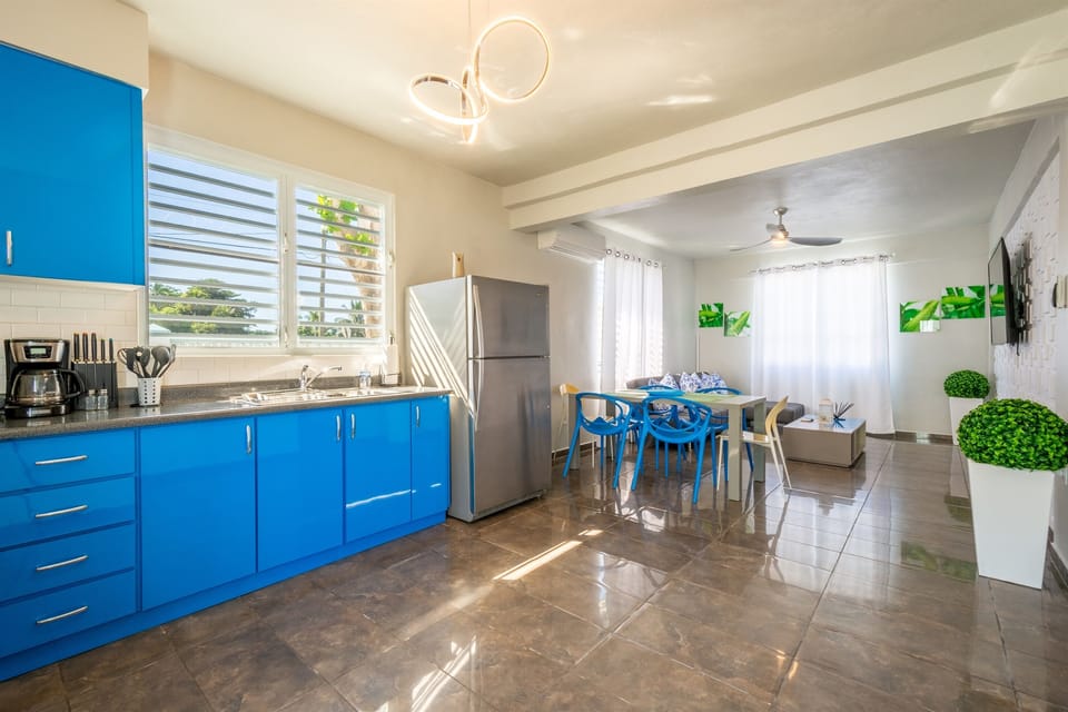 Kitchen & Dining Area: Bright blue cabinets and stylish decor invite culinary adventures!