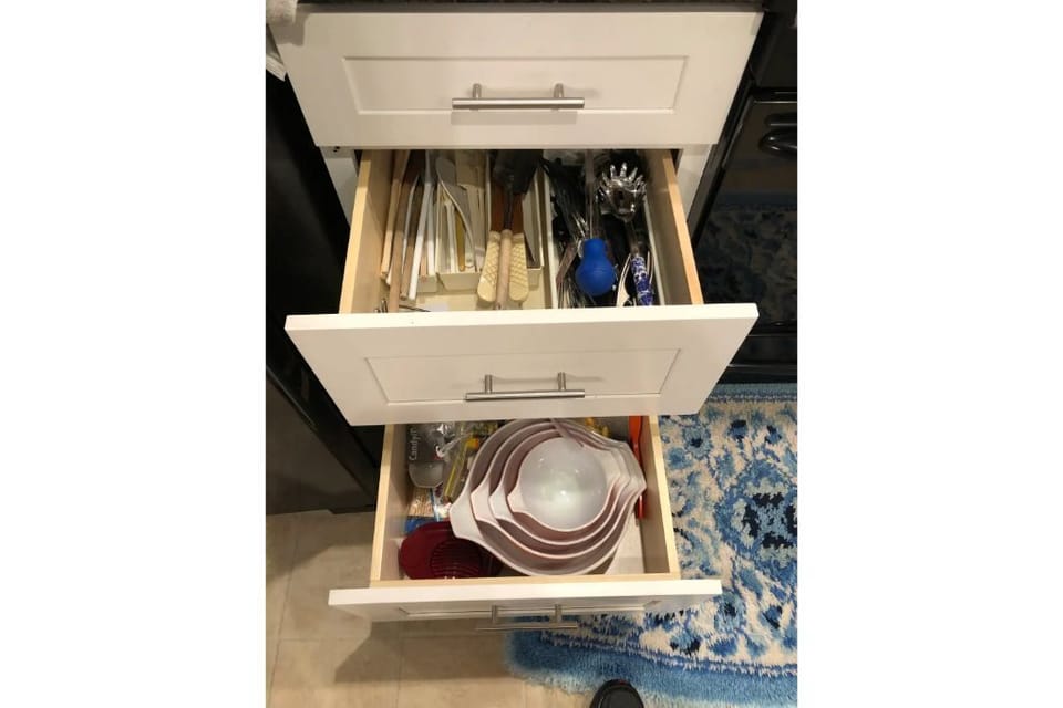 Stocked kitchen, food storage, mixing bowl, cutting boards, mixers, baking pans.