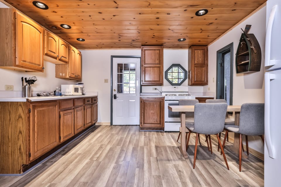 View of front door and kitchen.