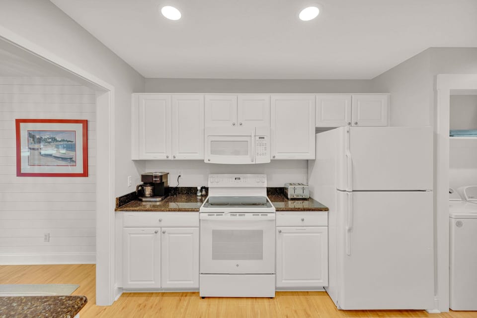 Kitchen with stainless steel appliances and fully stocked.