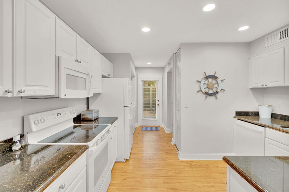 Kitchen with stainless steel appliances and fully stocked.