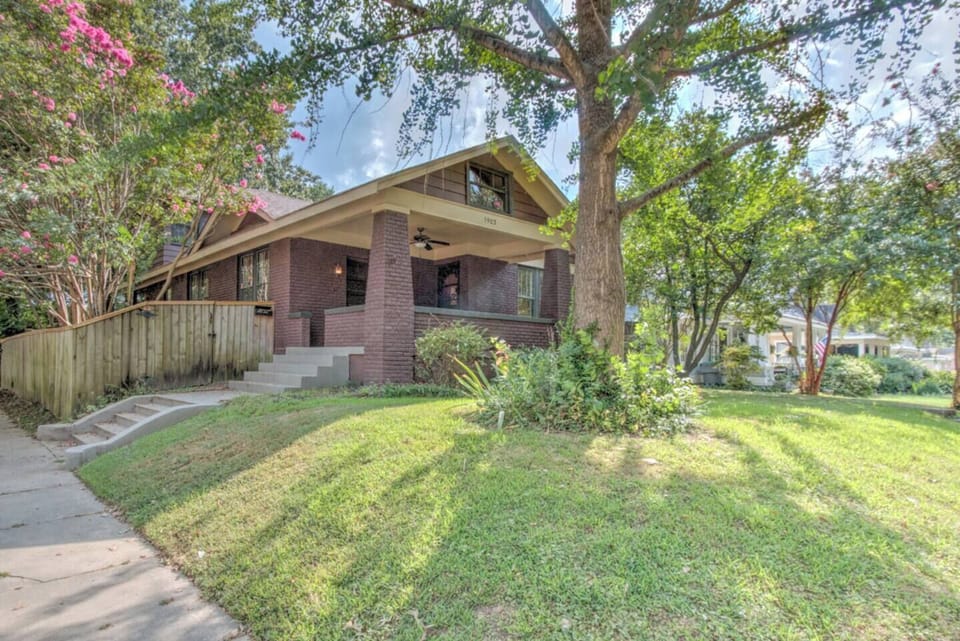 A timeless 1927 Craftsman surrounded by trees and Memphis charm.