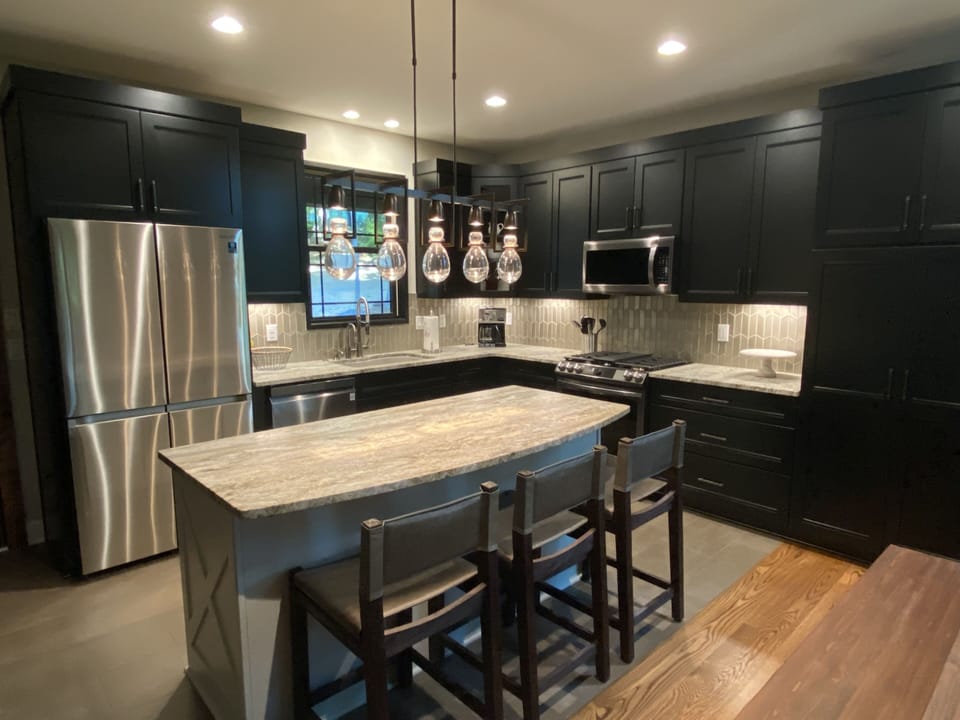 Kitchen fully furnished with gas stove, microwave, dishwasher and refrigerator