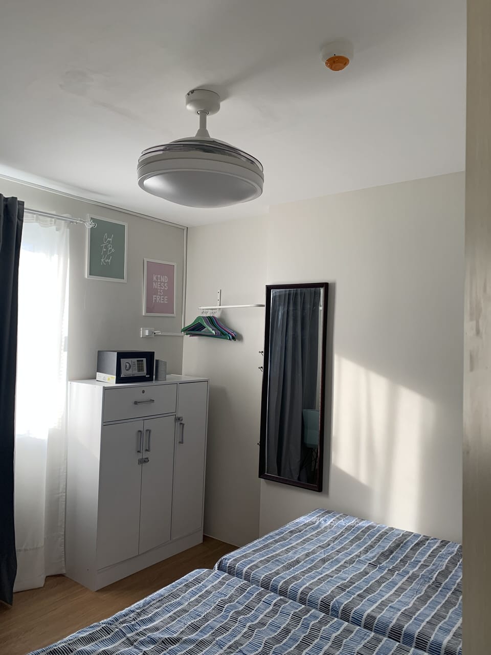 Bedroom 2 with split type air conditioner and retractable ceiling fan. 