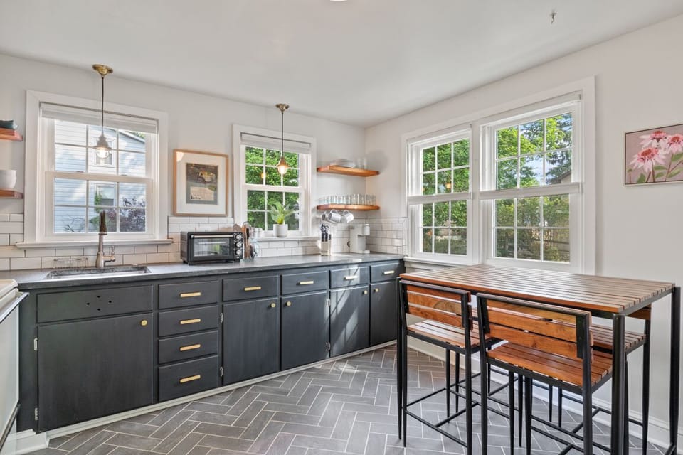 The dining table is nestled within the kitchen area.