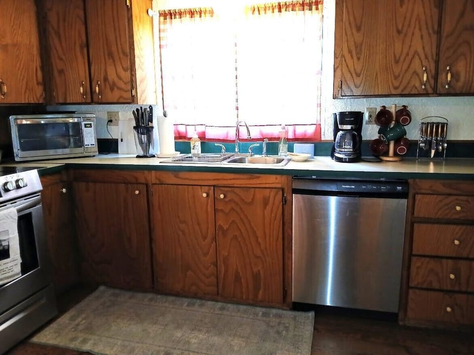 Kitchen showing coffee maker, dishwasher & toaster oven
