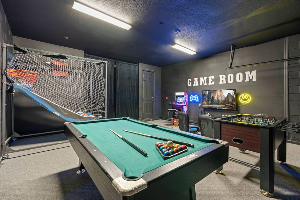 Welcome to our lively game room with a classic pool table and foosball table, enhanced by colorful wall art and stylish lighting. It’s the ideal place for family and friends to unwind and enjoy some friendly competition.