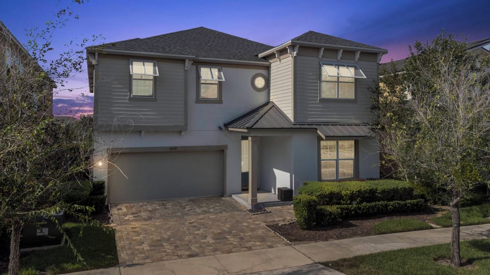 Step into this charming home, where the warm glow of twilight highlights the inviting stone pathway and landscaped front yard. Large windows allow natural light to spill in, providing a bright and airy atmosphere for your stay.
