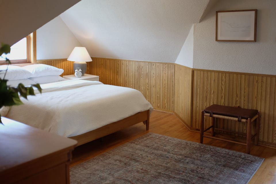 Primary bedroom with clean white linens