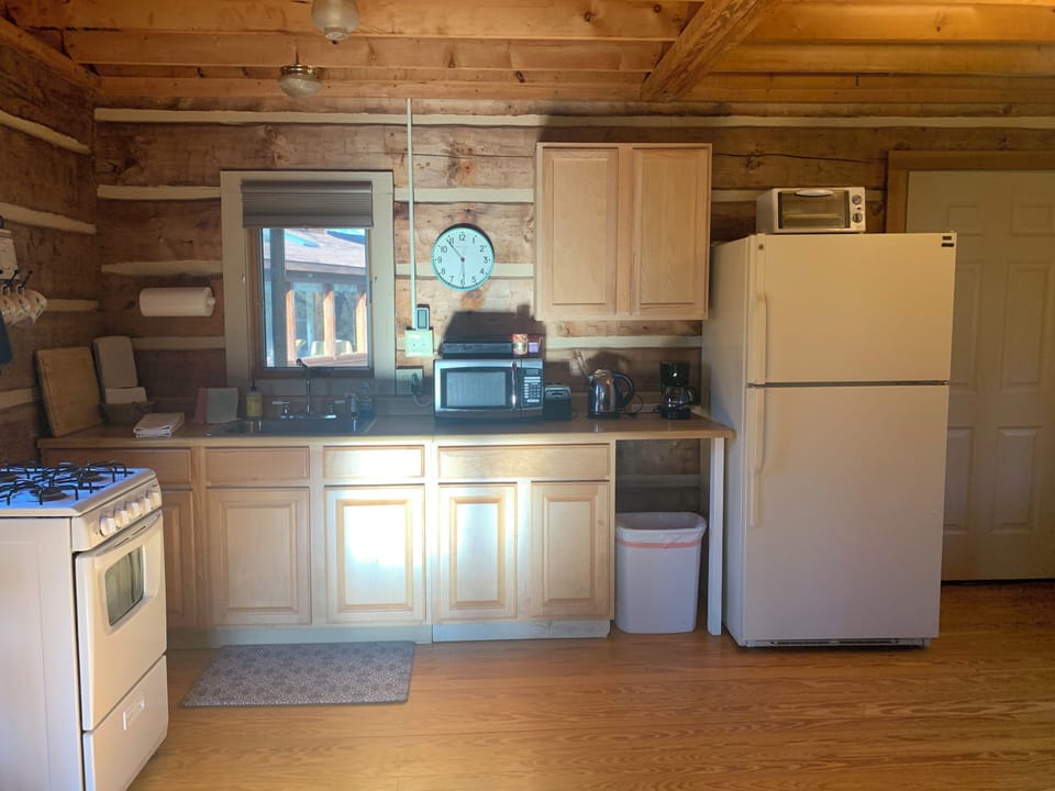 Fully stocked kitchen: utensils, cookware, dishes, wine glasses, spices, oils...