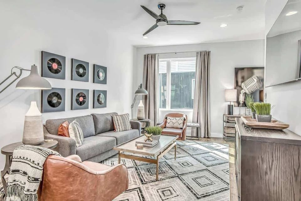 Retro vibes with vinyl art and stylish seating, perfect for relaxation and fun!