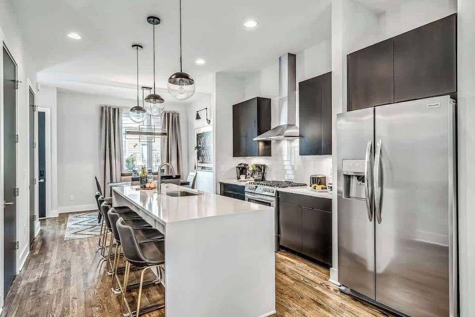 Enjoy cooking in a sleek kitchen with comfortable seating and abundant natural light