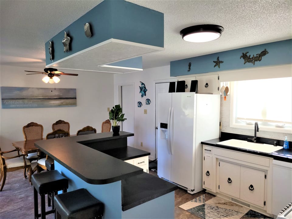 Wrap around eating bar adjoined to dining area.  Lots of natural light
