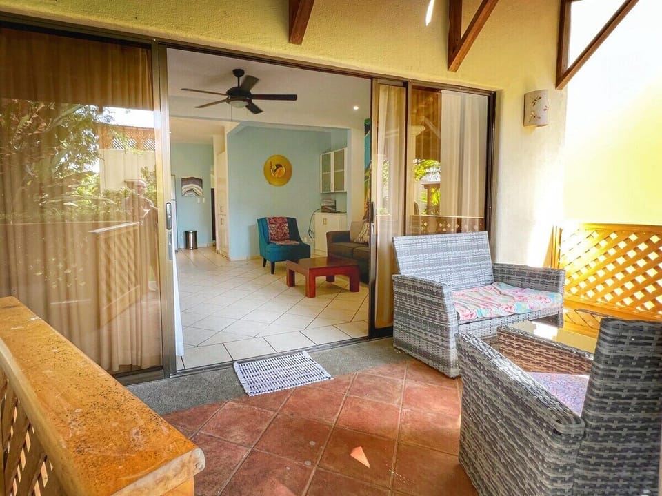 Beautiful, shaded terrace overlooking the tropical grounds.  Just steps one of several community pools.