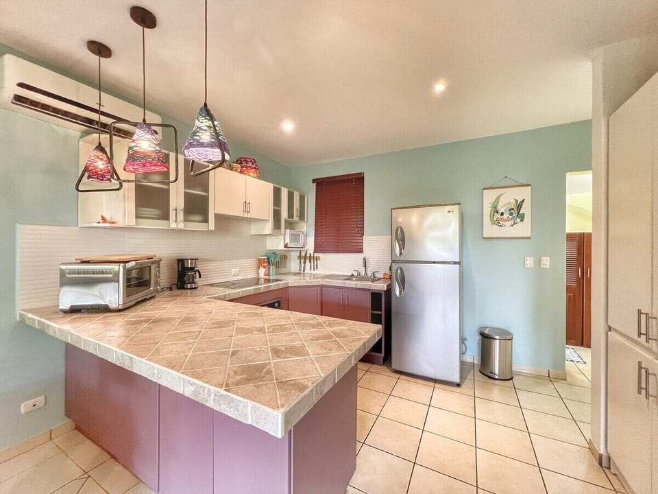 Fully equipped kitchen with ceramic cooktop, oven, and all small appliances.