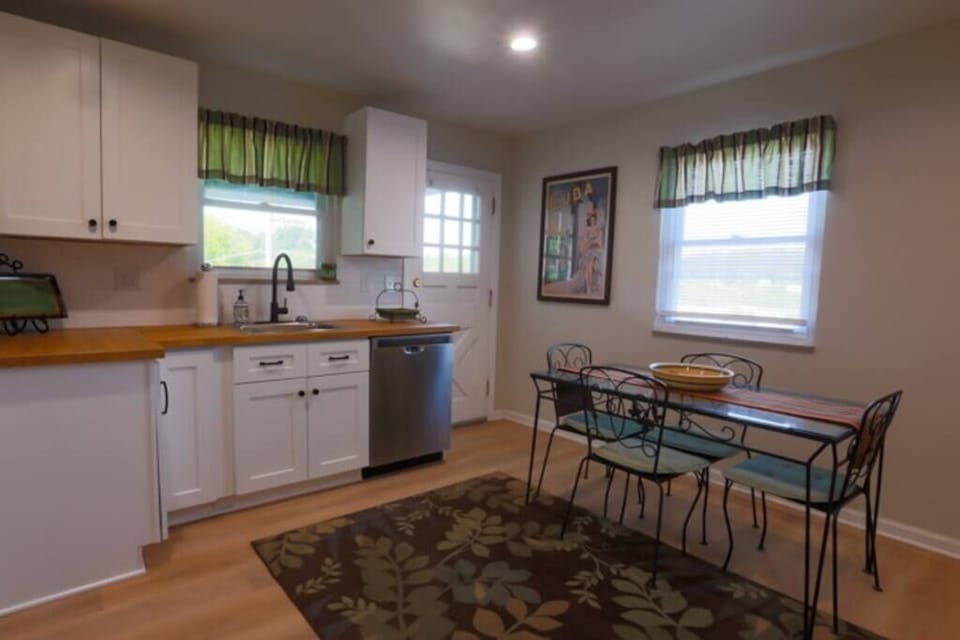 A view of the kitchen table and side door leading to the side patio.  