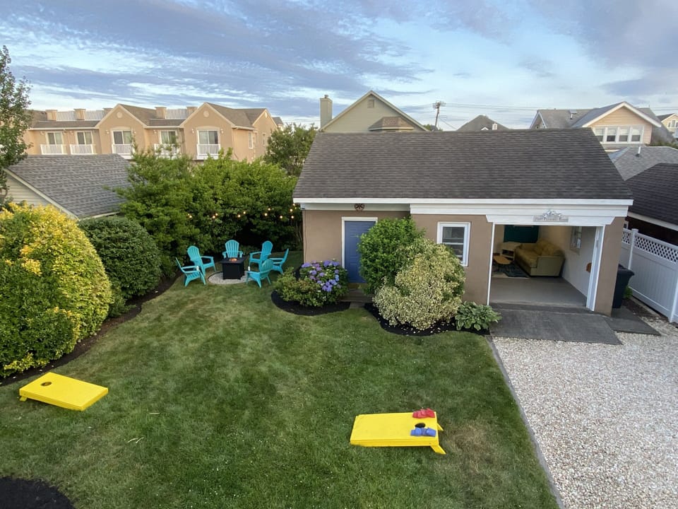 Backyard: gas fire pit, garage lounge, gas grill, dining & outdoor shower 