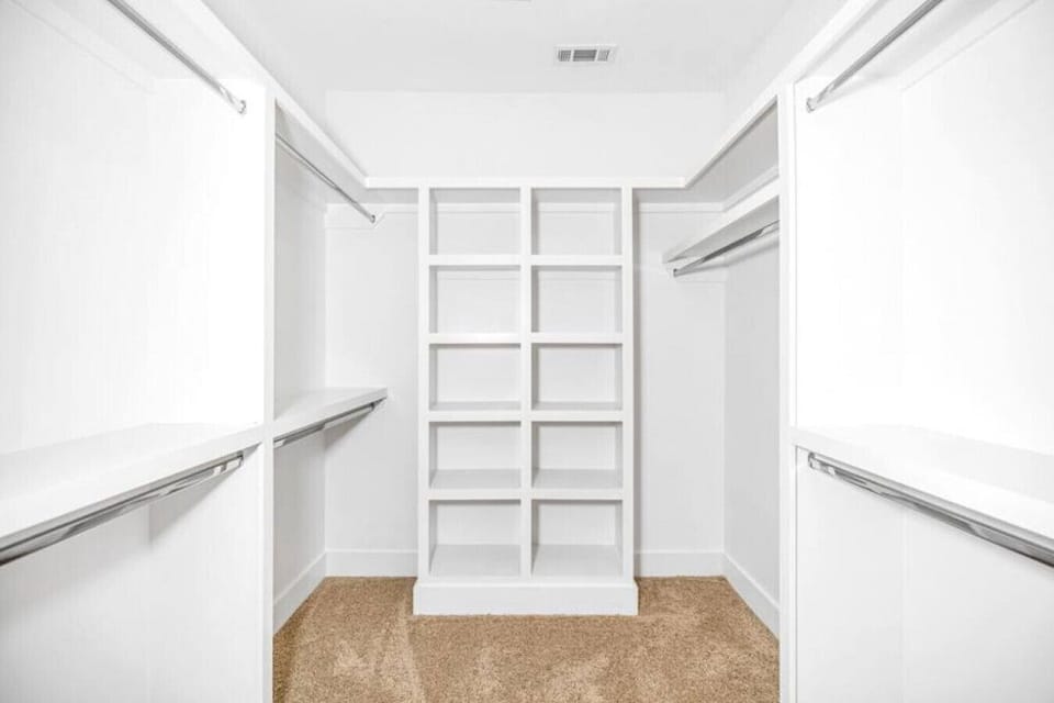 Walk in closet in the primary bedroom