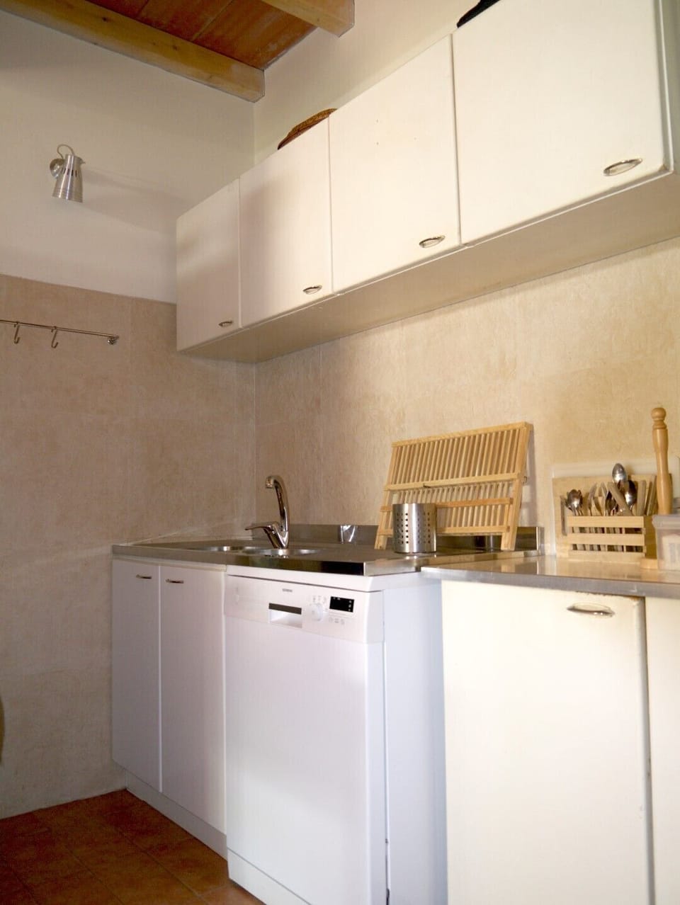 detail of washing up corner with dish washer.  Fridge and freezer are hidden
