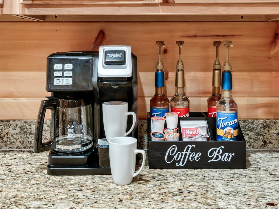 Enjoy your perfect cup of coffee with our dual coffee maker, which accommodates both K-cups and ground coffee. Plus, our charming mini coffee bar is stocked with everything you need to add a special touch of flavor to your brew.