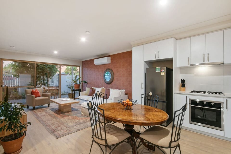 Spacious open-plan layout flowing from kitchen and dining to the private courtyard