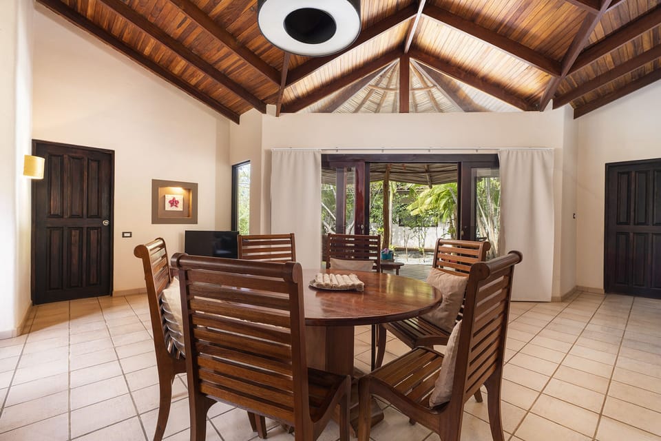 Dining area next to living with access to the patio