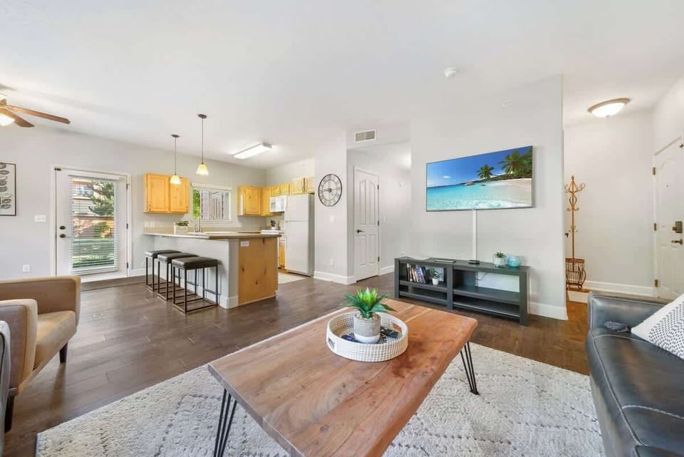 Big flat screen tv an open concept space that flows into the kitchen 
