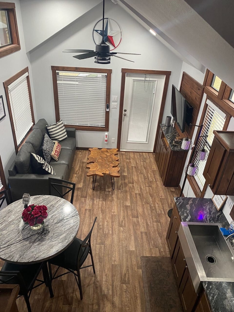 Aerial view of the main living space from second story in the tiny house.