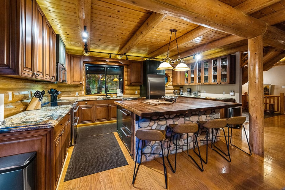 Rustic log kitchen, stone and wood details.
