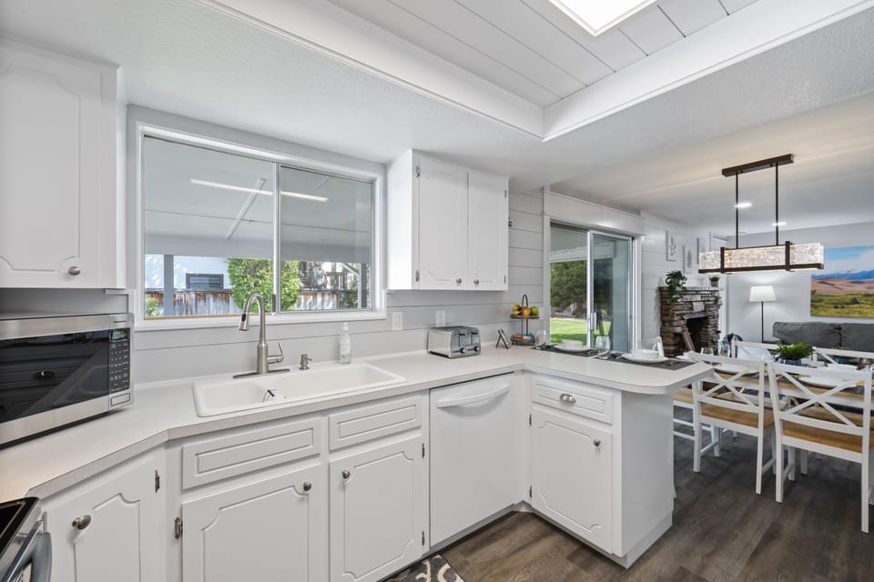 Kitchen with lots of amenities and a great view of the backyard and patio.