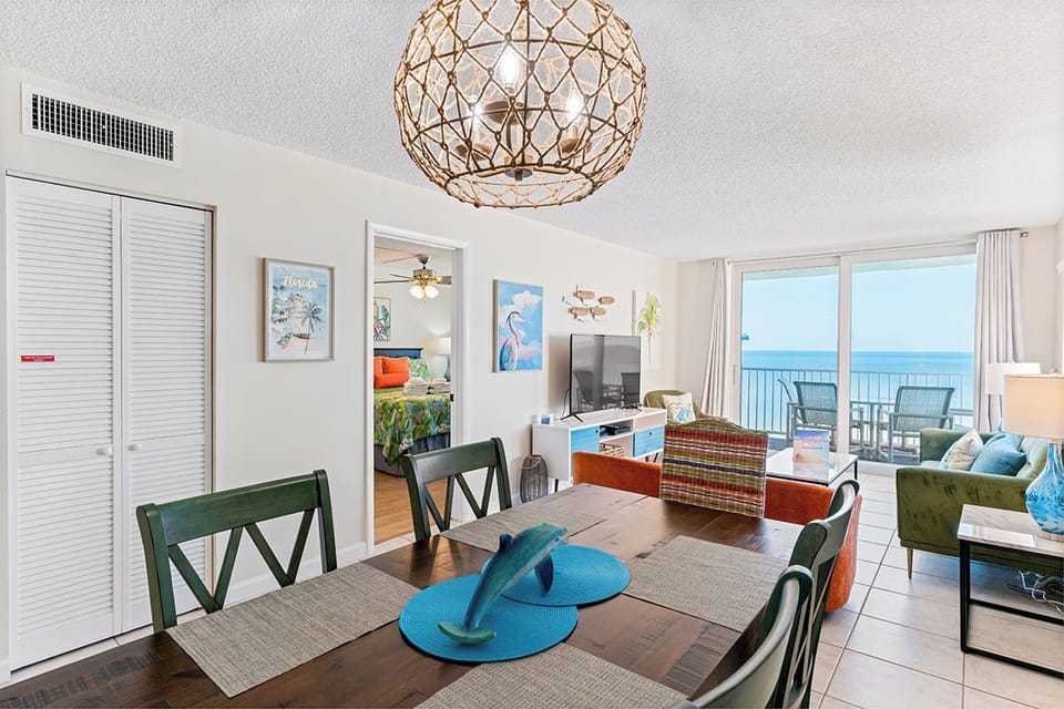 Your open-concept dining and living space features ocean views, coastal décor, and comfortable seating for memorable beachside gatherings.