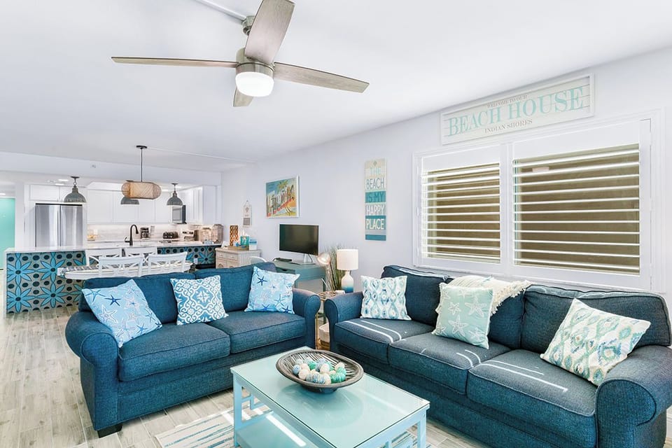 Sink into plush coastal sofas while ocean breezes flow through your bright, airy living space—perfectly designed for relaxation.