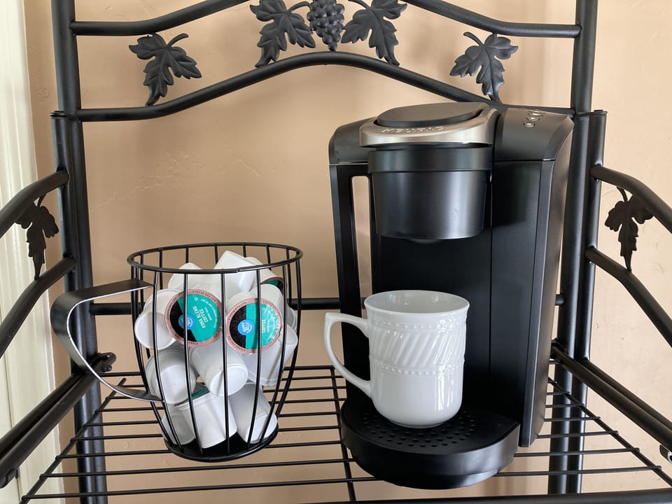 Keurig with coffee, sugar and creamers provided.
