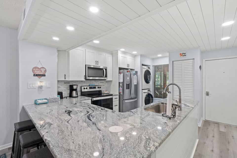 Your bright, modern kitchen features sleek granite countertops, stainless-steel appliances, and an airy open layout—perfect for preparing meals and unwinding after a day of exploring.