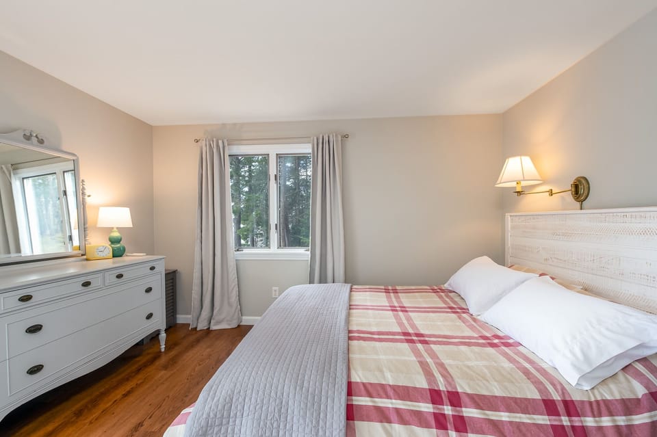 Bedroom on lower level, access to deck. Queen bed.