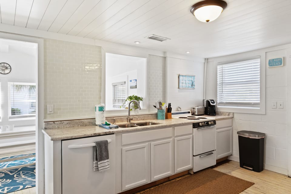 Coastal-inspired kitchen with granite countertops and stainless appliances. 