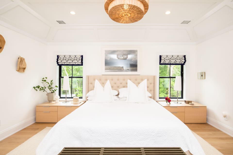 Primary bedroom overlooking swimming pool and backyard. 