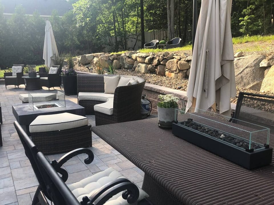 Dining Outdoor-with tabletop fireplace. Stone patio custom two level.Three. Seating areas two  umbrellas.
