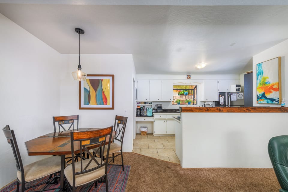 Dining/Kitchen. Coffee bar with Keurig, brew pot, & espresso machine. 
