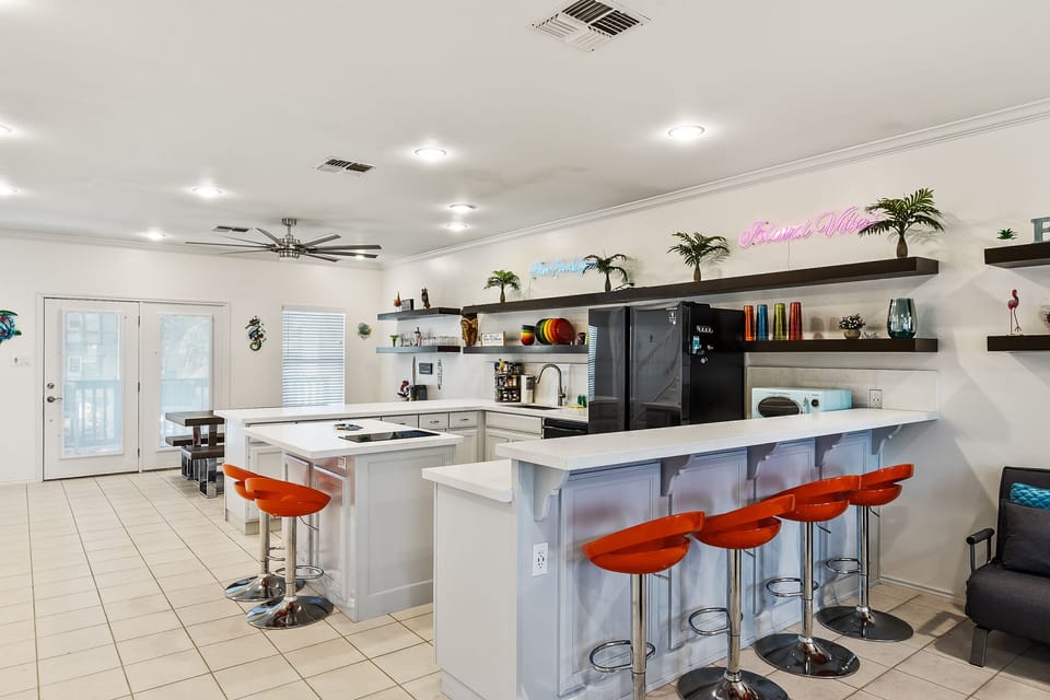 Open concept kitchen features wrap around bar seating (on all sides) and updated appliances!