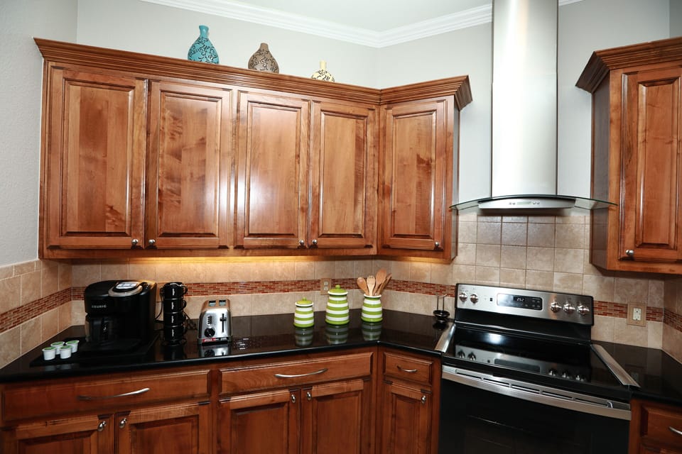 Well equipped kitchen with Keurig coffee maker, toaster, and electric stove