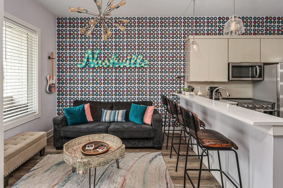 Cozy living room area with a pull-out sofa plus Smart TV with apps. Seating for 5 at the kitchen counter.