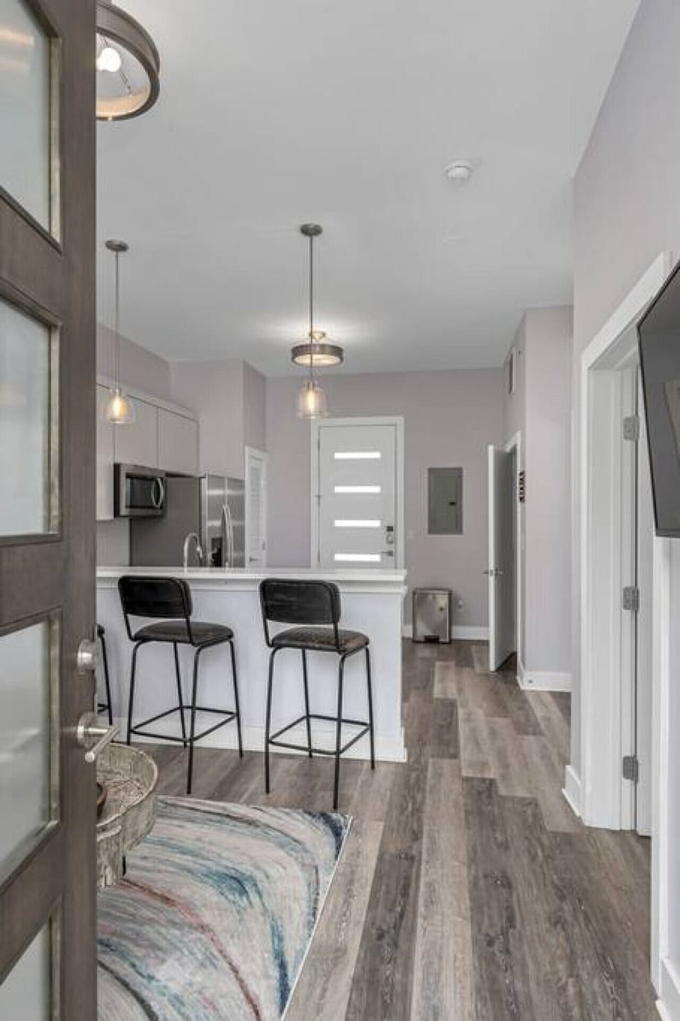 Cozy living room area with a pull-out sofa plus Smart TV with apps. Seating for 5 at the kitchen counter.